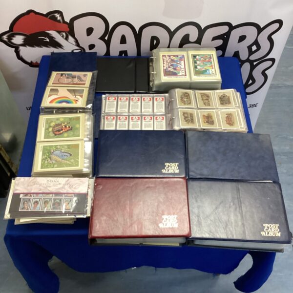 Vintage collector card albums filled with cigarette cards, postcards and stamps.