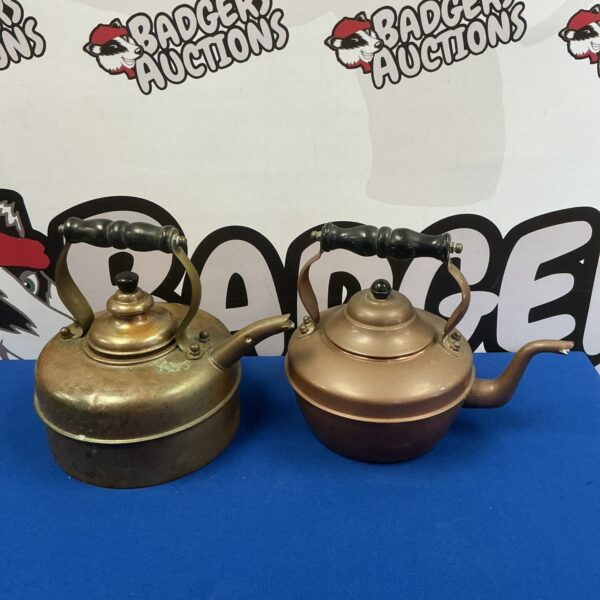 Two vintage copper kettles with patina and handles.