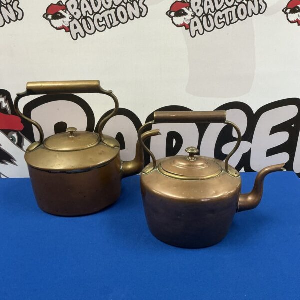 Pair of vintage copper kettles with patina and handles.