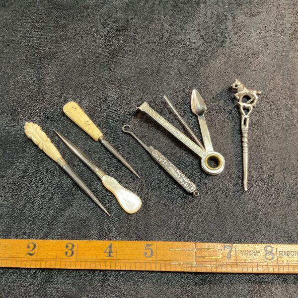 Vintage crafting tools assortment including button hook and awls.