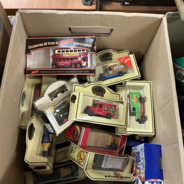 Vintage diecast toy cars in boxes, a collectible lot for enthusiasts.