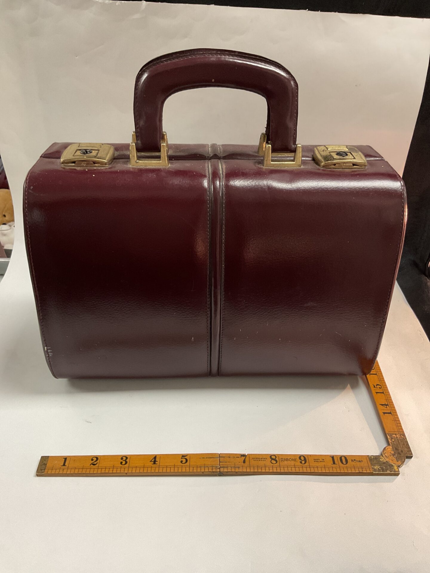 Front view of a vintage red leather doctors bag.
