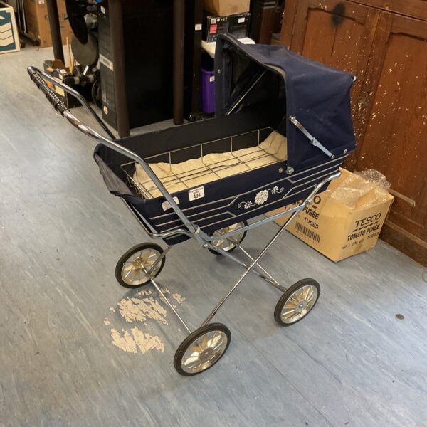 Side view of a vintage dolls pram with woven basket.