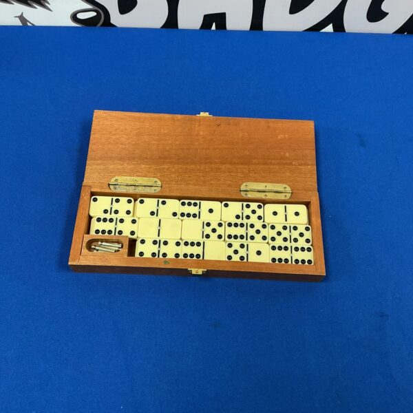 Closed vintage dominoes and cribbage set on blue background.