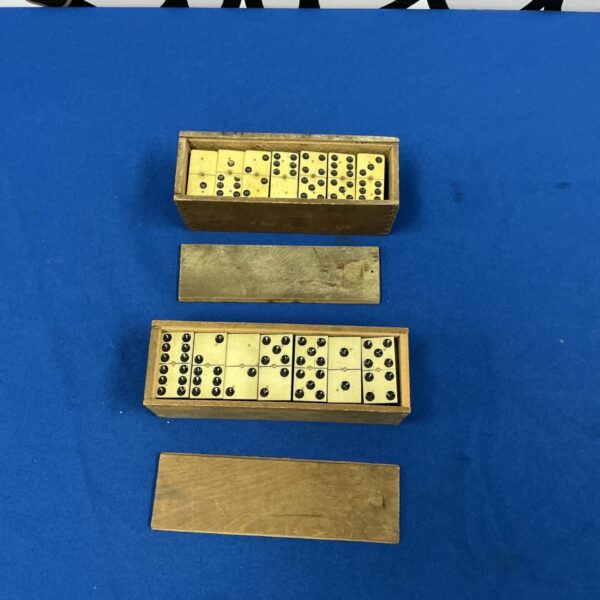 Vintage dominoes sets presented in their original wooden boxes.