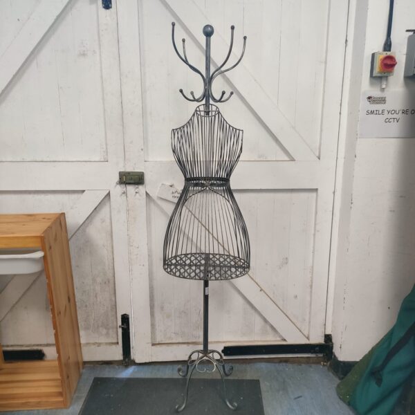 Vintage dress maker’s mannequin stand for displaying coats and hats.