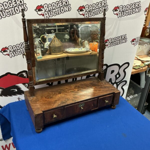 Vintage dark wood dresser with mirror for bedroom storage.
