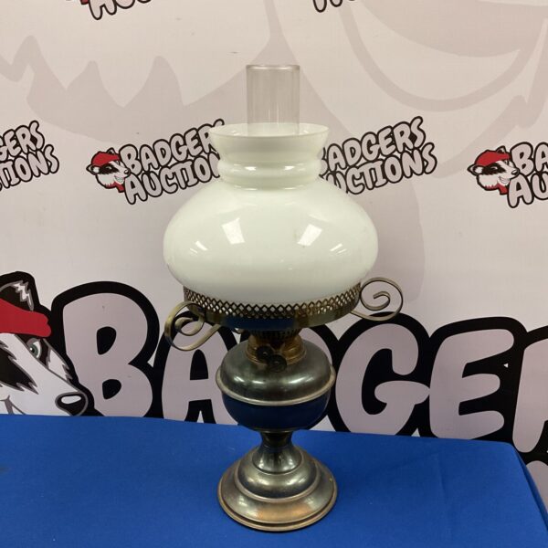 Vintage duplex paraffin lamp with white glass shade.