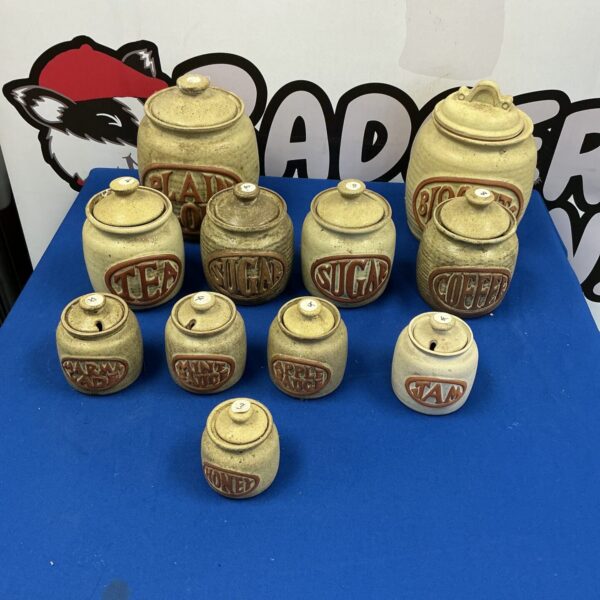 Vintage earthenware kitchen storage jars, rustic pottery collection.