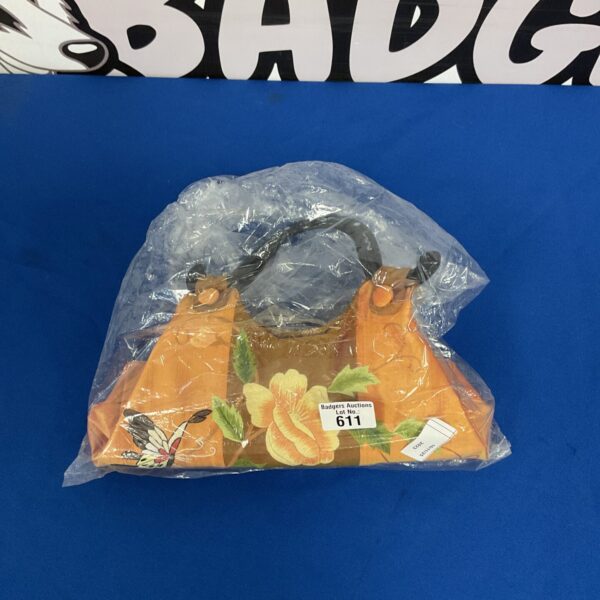 Vintage embroidered handbag with floral design.