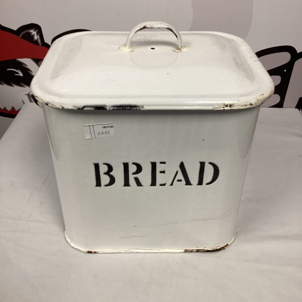 Vintage enamel bread bin for kitchen storage, showing wear.