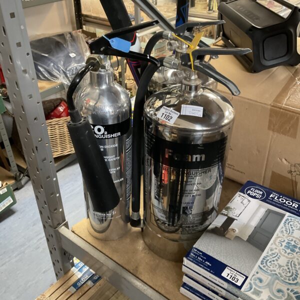 Vintage chrome fire extinguishers showing pressure gauges.