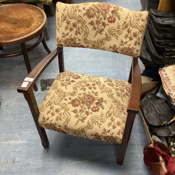 Vintage floral bedroom chair with wooden frame.