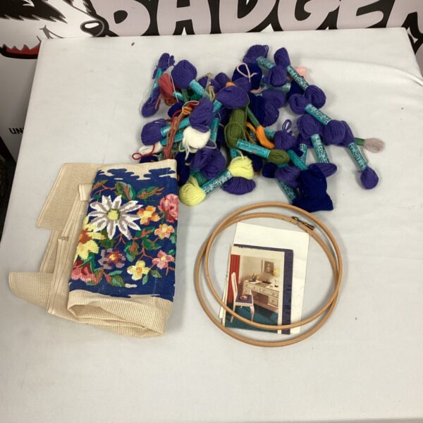 Vintage floral tapestry set with embroidery hoop and threads.