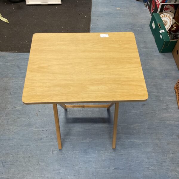 Vintage folding wooden table, ideal for small spaces.