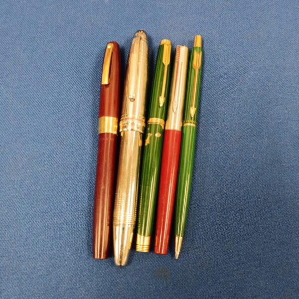 Group of vintage fountain pens, including a gold Parker pen.