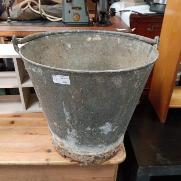 Large vintage galvanised bucket with handle, rustic farmhouse style.