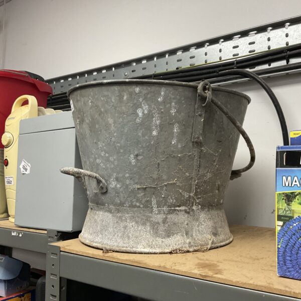 Weathered vintage galvanised bucket for rustic farmhouse decor.
