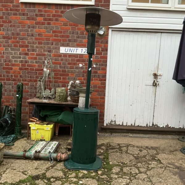 Green vintage gas patio heater for outdoor garden use.
