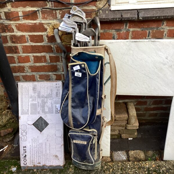 Vintage golf bag with assorted clubs, including Dunlop and Gary Player.