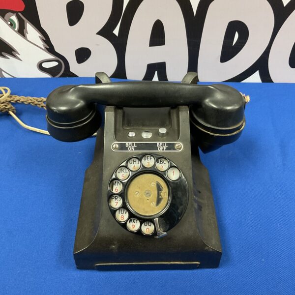Vintage black bakelite GPO telephone with rotary dial.
