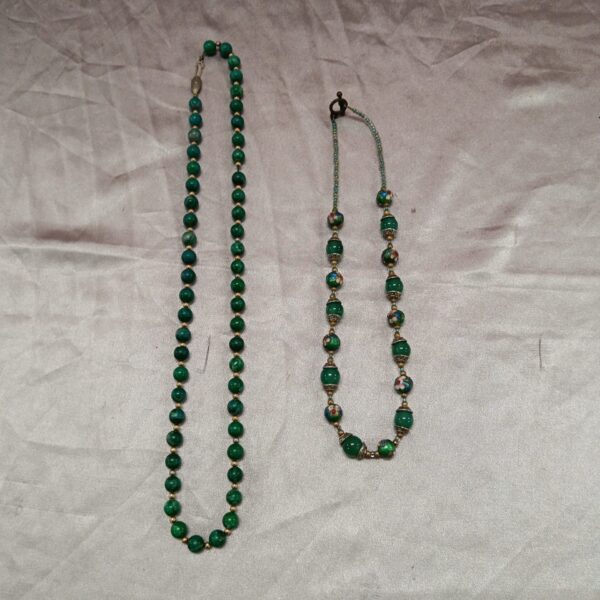 Close-up of a vintage green stone and glass beaded necklace.