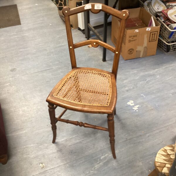 Vintage hall chair with woven seat and wooden frame.