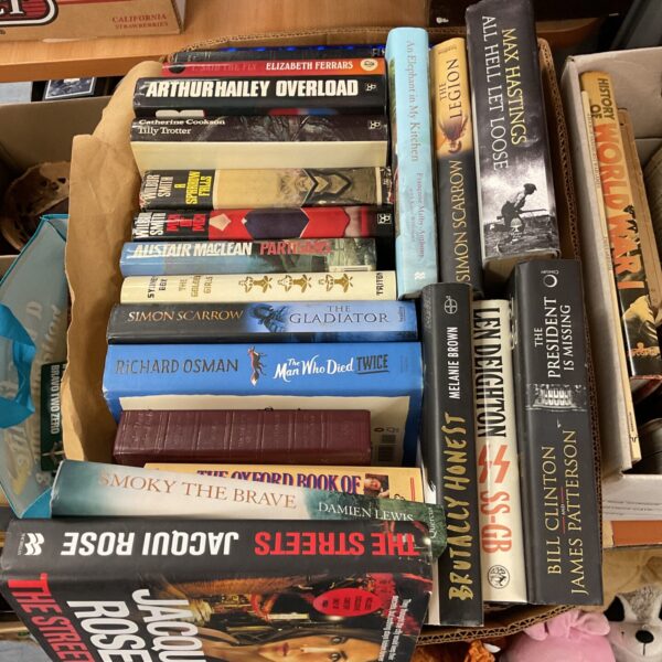 A stack of vintage hardback books including Simon Scarrow novels.