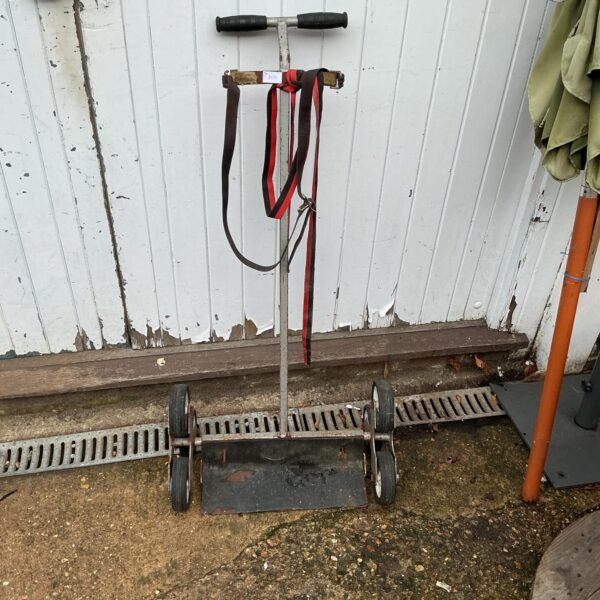 Vintage Irish harp trolley for safe instrument transport.