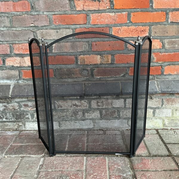 Vintage iron trifold firescreen for fireplace safety and style.