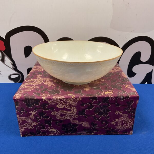 Vintage Japanese eggshell bowl on patterned box.