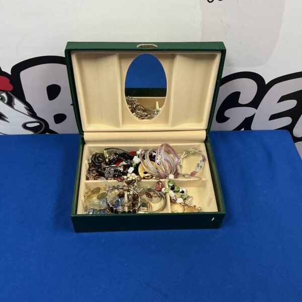 Vintage jewellery box with an assortment of costume jewellery inside.