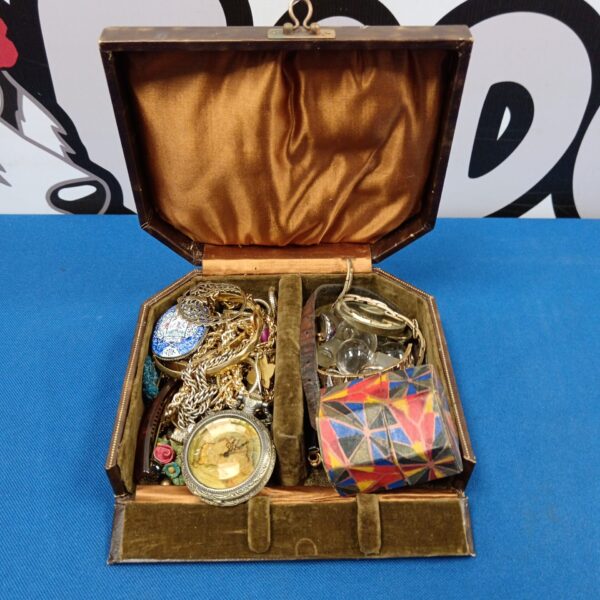 Vintage jewellery case with gold plated necklaces and antique accessories.