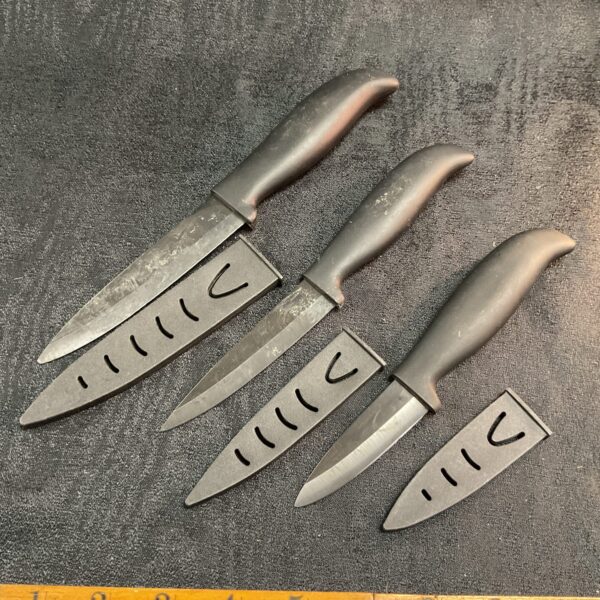 Set of three vintage kitchen knives with stainless steel blades.