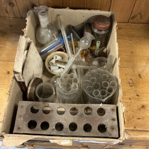 Vintage lab glassware collection with test tubes and beakers.