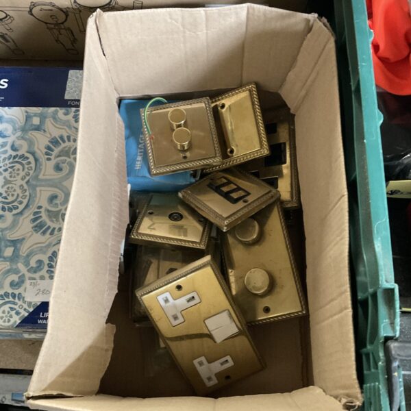 Vintage brass effect light switches and sockets in a lot.