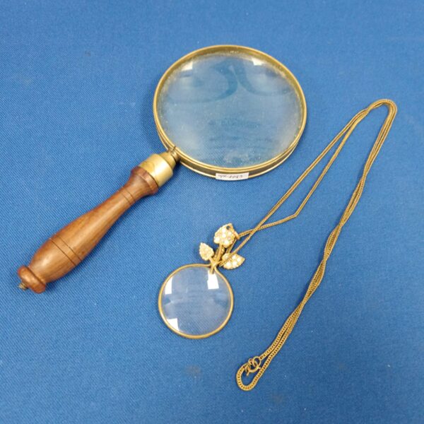 Vintage magnifying glass with carved wooden handle.