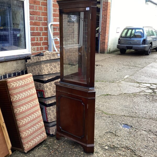 Vintage mahogany corner display cabinet with glass front.