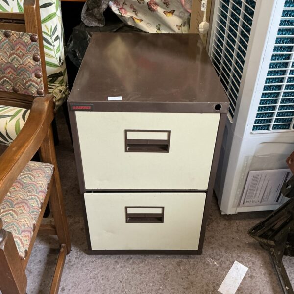 Vintage metal filing cabinet with two drawers for office storage.