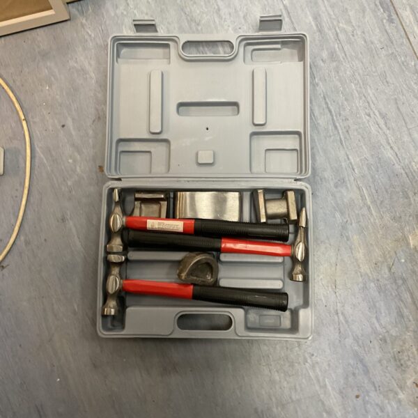 Vintage metalworkers hammer set in a fitted case, showing various hammer forms.