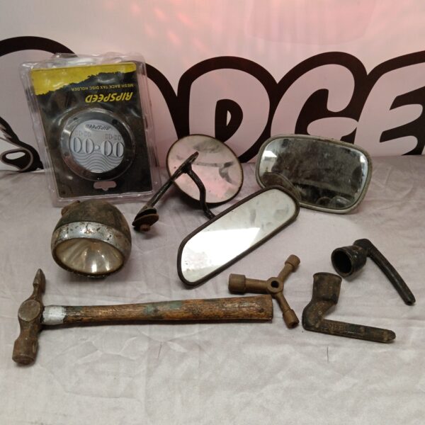 Vintage motorcycle side mirror with chrome housing and convex glass.