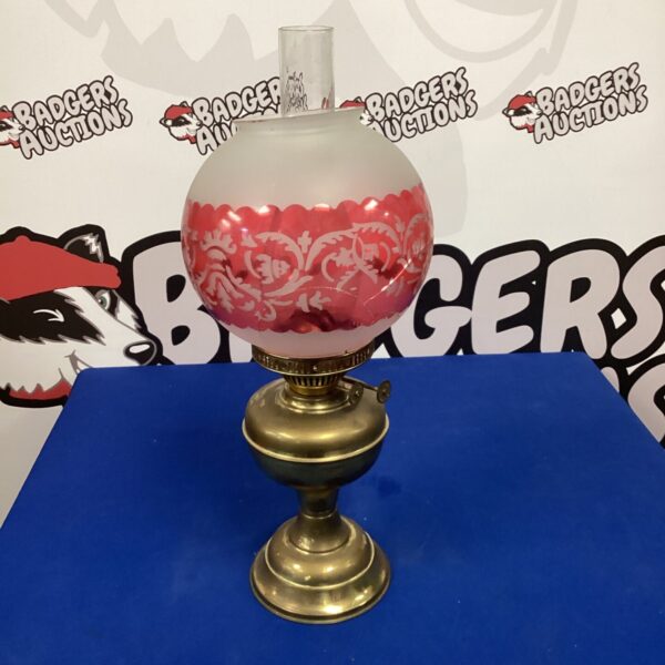 Vintage paraffin oil lamp with glass shade and brass base.