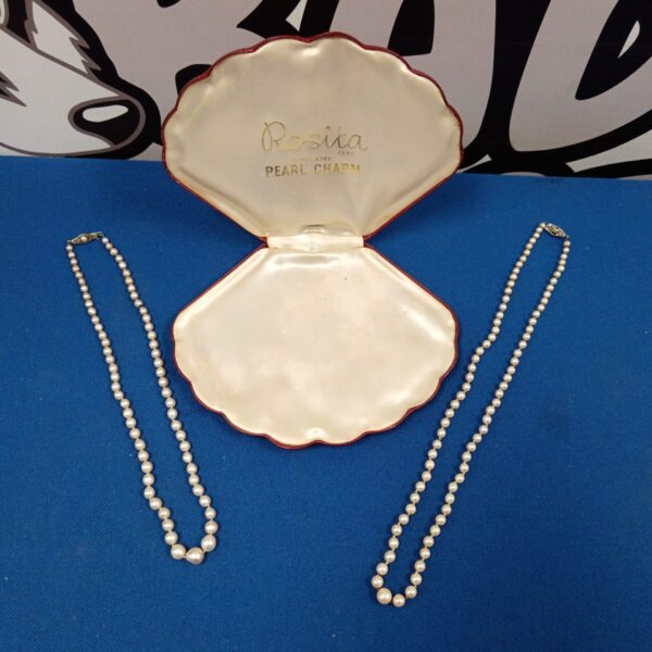 Vintage pearl necklaces with silver clasps, a classic jewellery pair.
