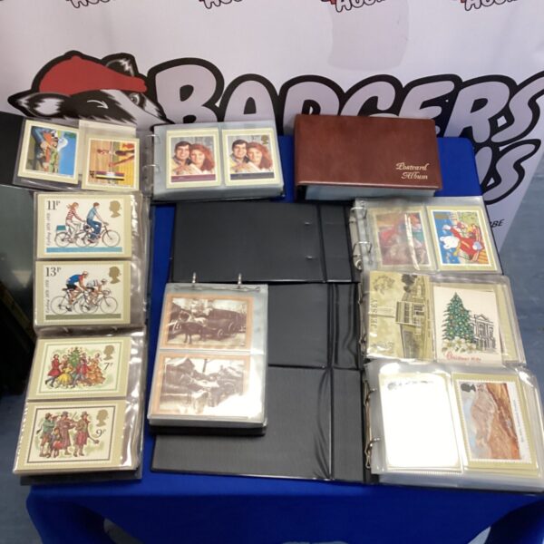 Vintage postcard albums with postcards inside, collectible ephemera.