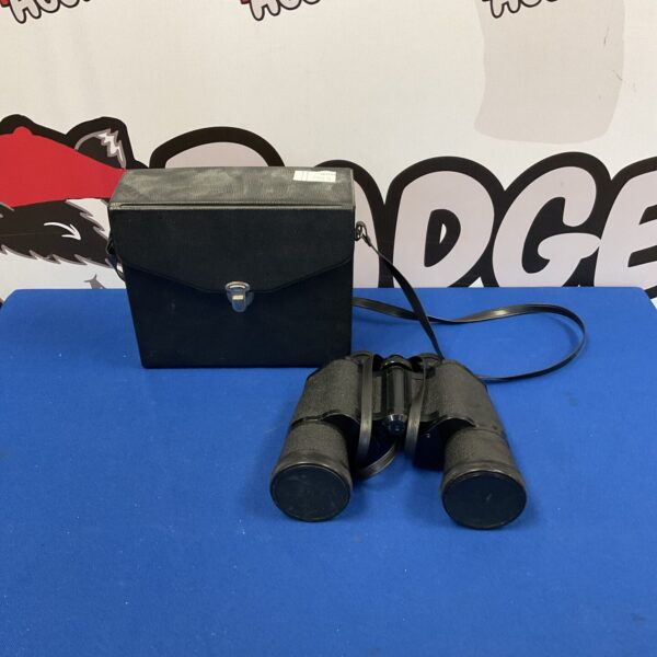 Vintage Prinz 10x50 binoculars with coated optics, side view.