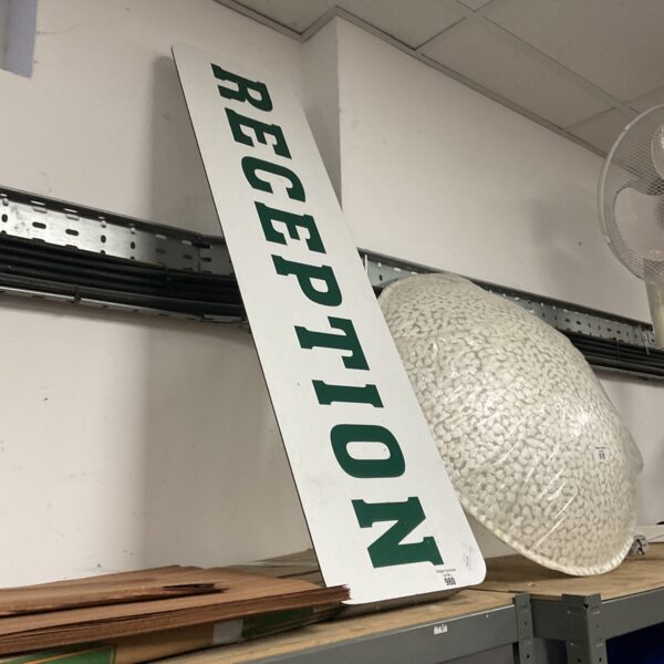 Vintage white reception sign with black lettering.