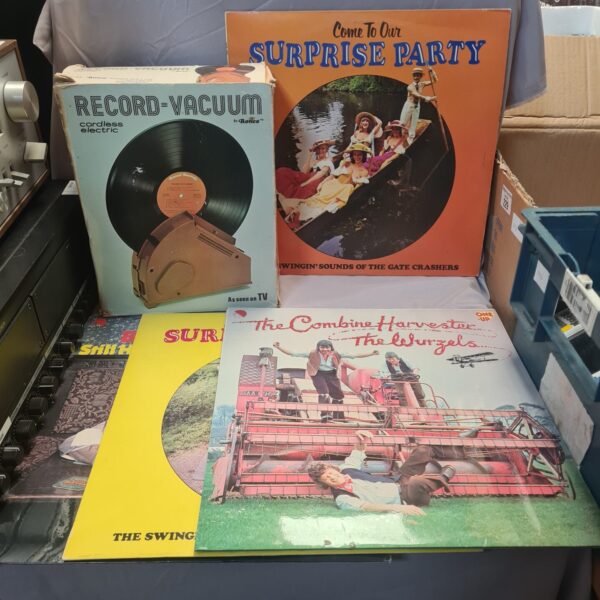 Vintage Record Vacuum Model 77 with records in original packaging.