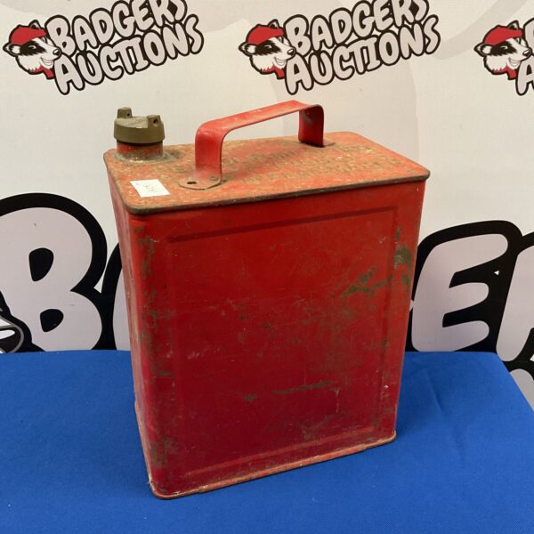 Vintage red fuel can with brass cap, collectible metal gas can.