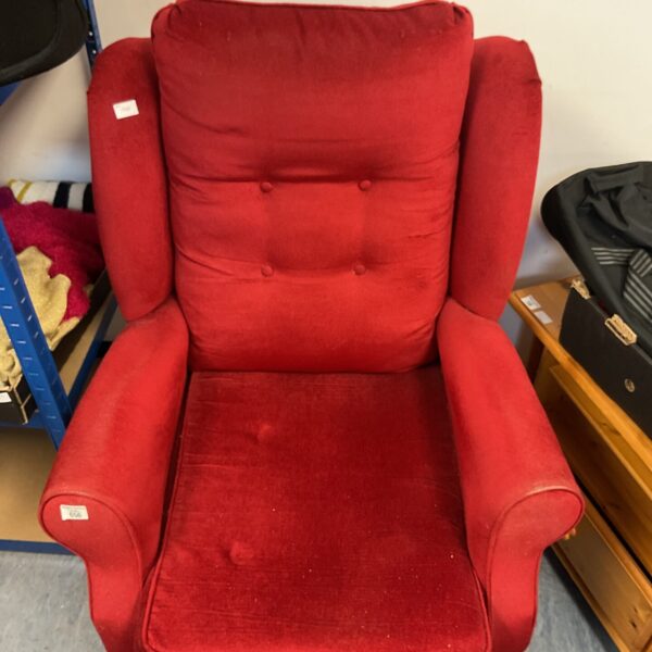 Vibrant red vintage wingback chair with classic design.