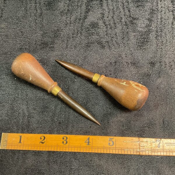 Vintage rope splicing spikes with wooden handles and steel points.